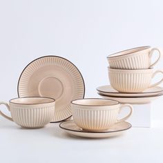 a set of four cups and saucers