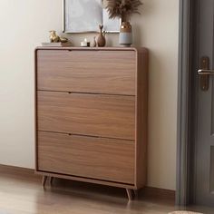 a wooden dresser sitting next to a door