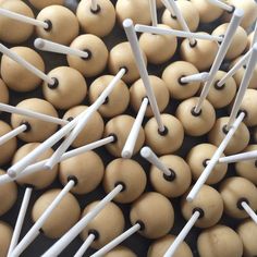 there are many wooden beads with white pins in them on the table and they look like toothpicks