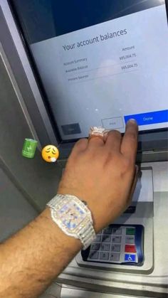 a man is using an atm machine to pay for his money and other things on the screen