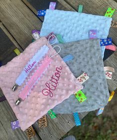 three personalized baby blankets sitting on top of a wooden bench