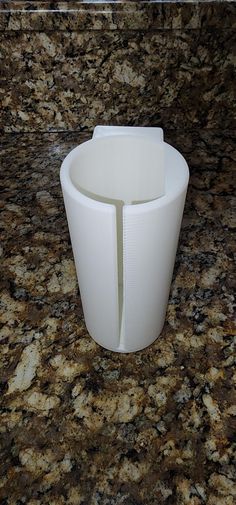 a white cup sitting on top of a counter