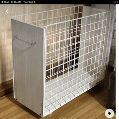 a white refrigerator freezer sitting on top of a wooden floor next to a wall