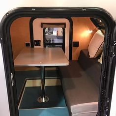 the inside of an rv with a table and couch