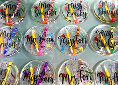 many personalized glass magnets are displayed on a table with confetti in them