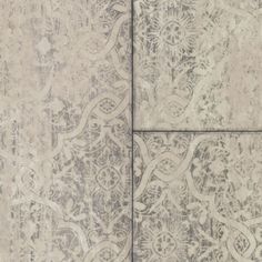 a tile floor with an intricate design on the top and bottom part, in grey tones