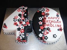 a birthday cake with the number forty on it's side, decorated in black and red flowers