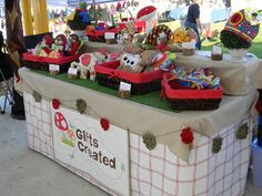 a table topped with baskets filled with lots of stuffed animals and other stuff on top of it