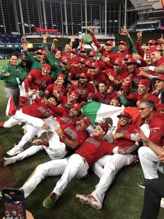 the baseball team is posing for a group photo with their trophy in front of them