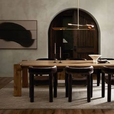 a dining room table with four chairs around it