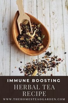 a wooden spoon filled with herbs and tea on top of a white table