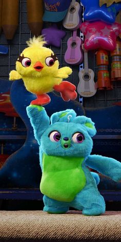 two stuffed animals standing next to each other in front of guitars and wall hangings