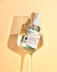 a wine glass filled with white liquid and an adhesive sticker on the side