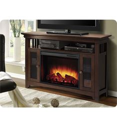 an entertainment center with a fireplace and television