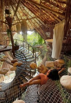 a woman laying on top of a hammock covered in doughnuts