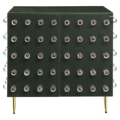 a green cabinet with lots of silver dots on it