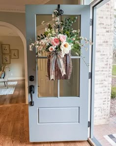 the front door is decorated with flowers and ribbons