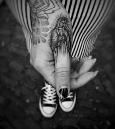 a woman's hand with a tattoo on it