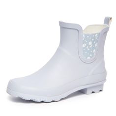 PRICES MAY VARY. Stay Dry in Style: Laura Ashley ladies mid cut ankle height rubber rain boots offer both fashion and function. Keep your feet dry and stylishly protected from the elements with these chic waterproof booties, perfect for rainy days or outdoor activities. Comfortable All-Day Wear: Designed for comfort, these rain boots feature a cushioned insole and fabric lining to keep your feet cozy and supported, even on the longest of rainy days. The round toe and wide cuffs ensure a comfortable fit for all-day wear. Durable Construction: Constructed with a waterproof rubber upper and heavy-duty lug sole, these boots are built to withstand wet and slippery conditions. The Chelsea cut and side goring provide easy on and off, while the pull tag adds convenience. Versatile Style: With a ma Chelsea Cut, Booties For Women, Rainy Weather, Wide Cuff, Laura Ashley, Lug Sole, Rainy Days, Versatile Style, Rubber Rain Boots