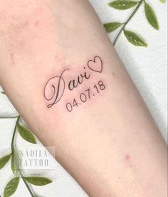 a small tattoo with the word david written in cursive writing on it's arm