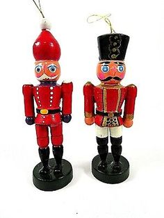 two red and black nutcrackers are standing next to each other