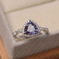 This ring features a 8*8 mm trillion cut lab alexandrite. Customization is available. It is made by hand, and it will take about 7 days to finish the ring after your payment is completed.  Main stone: 8*8 mm trillion cut lab alexandrite Main stone weight: 0.00 ct Metal type: sterling silver /14k gold Accent stone: cz   Customization is available, just fee free to contact me, it is free to engrave inside the ring, it is free, you can leave a ntoe with your order, but it will be great no more than 15 letter. Any question, just let me know. :) My shop homepage: https://www.etsy.com/shop/LuoJewelry?ref=l2-shopheader-name Trillion Cut Engagement Ring, Trillion Cut Ring, June Birthstone Ring, Silver Engagement Ring, Alexandrite Ring, Tanzanite Ring, Sterling Silver Engagement Rings, Silver Wedding Rings, Pretty Clothes