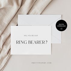 a white card with the words ring bearer on it next to an envelope that says will you be our ring bearer?