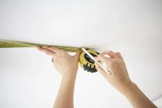 a person measuring the ceiling with a tape measure