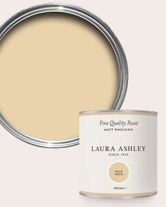 a can of paint with the lid open to show it's light beige color