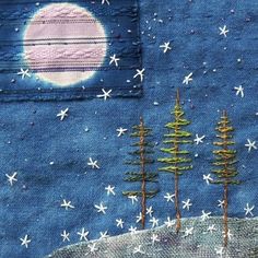 a patchwork piece with trees and stars on it, in front of a full moon