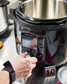 a person is checking the time in an instant pot