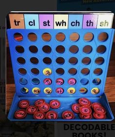 a blue board game with letters and numbers on it