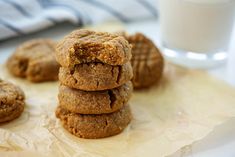 a stack of cookies sitting on top of a table next to a glass of milk