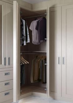 an open closet with clothes hanging on hangers