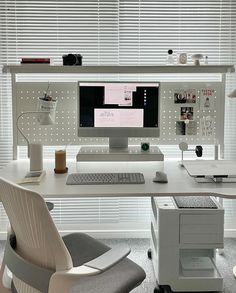 a white desk with a computer monitor and keyboard