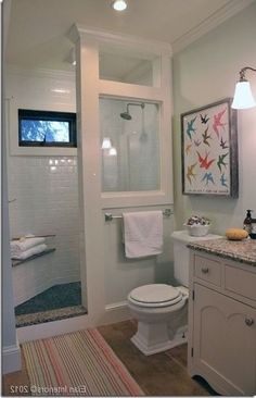 a bathroom with a sink, toilet and shower