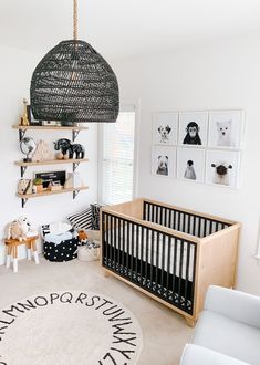 a baby's room is decorated in black and white