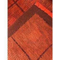 an orange and brown area rug with squares on the bottom, in two different colors