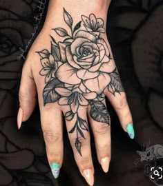 a woman's hand with flowers on it