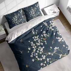 a bed with white flowers and blue sheets