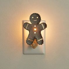 a light that is on the side of a wall with a gingerbread man in it