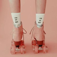 a pair of pink roller skates with socks that say, i did my best