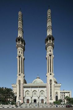 two tall towers are in front of a building