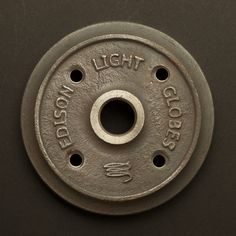 a metal object with words on it that says, no light goes out in the dark