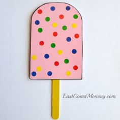 a popsicle decorated with polka dots on a stick