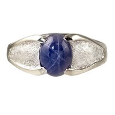 a silver ring with a blue stone on it