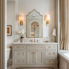 a white bathroom with two sinks and a large mirror