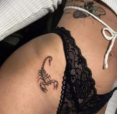 a woman with a scorpion tattoo on her stomach