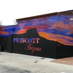 a mural on the side of a building that says, prescot arizona with a mountain in the background