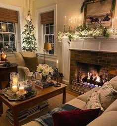 a living room filled with furniture and a fire place in front of a christmas tree